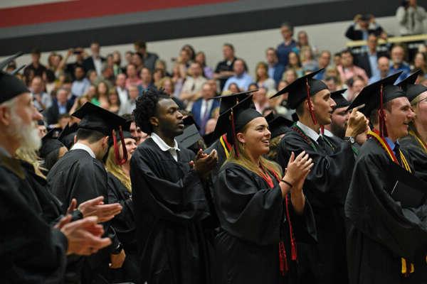 graduation class with caps on in the gym